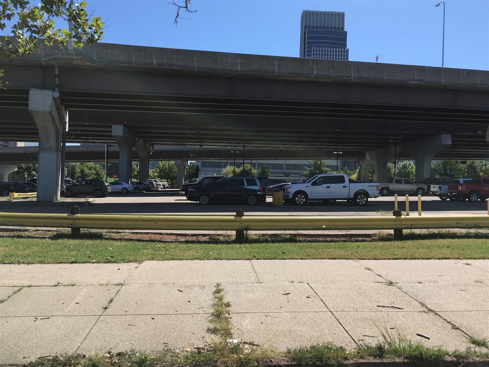 Modern image of vehicles parked under an overpass where Jefferson Square previously was